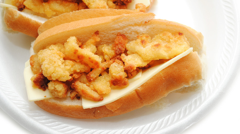 Fried clam sandwich served on New England-style roll with cheese