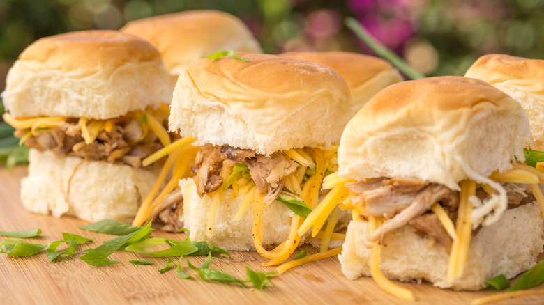 Kalua pork with shredded cheese on slider buns