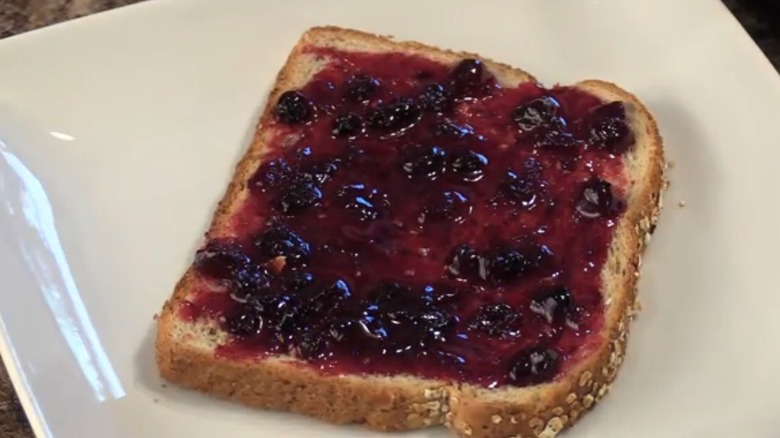 Homemade Idaho huckleberry jam spread on multigrain sandwich bread