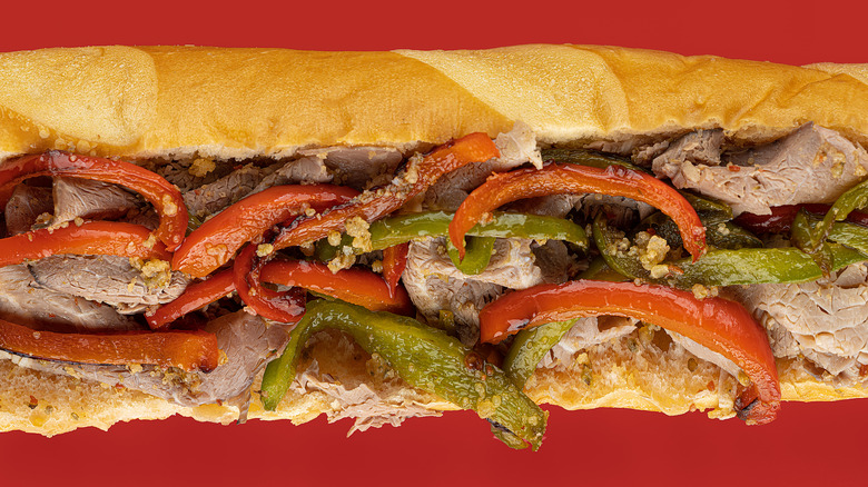 Italian beef sandwich on a red background