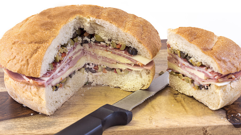 Large muffuletta sandwich with one quarter cut out