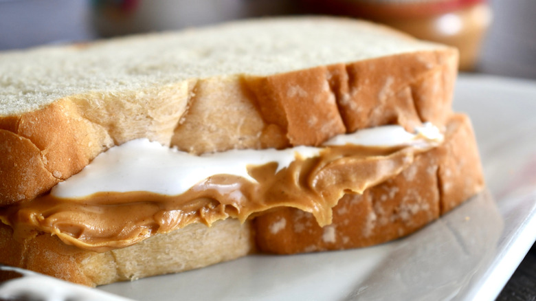 Fluffernutter (peanut butter and Marshmallow Fluff) on white sandwich bread on a white plate