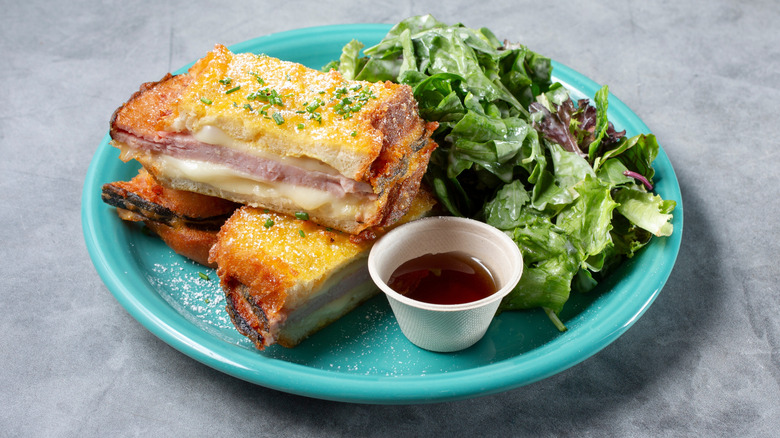 Monte Cristo sandwich with side salad on blue plate