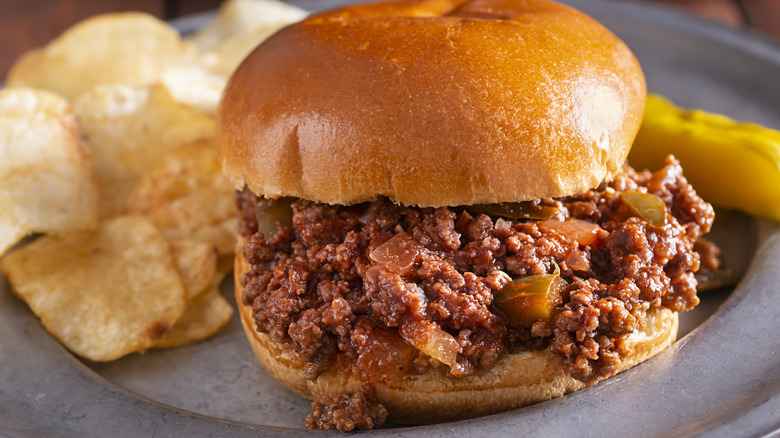 Sloppy Joe on a gray plate with potato chips