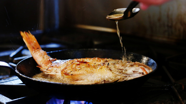 Fish pan frying on stove