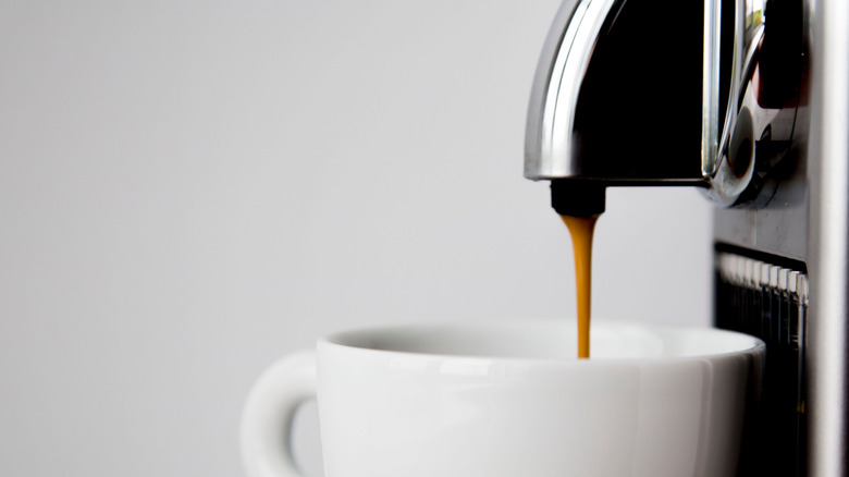Espresso pulling into white mug