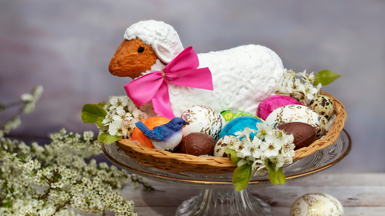 decorated lamb cake surrounded by chocolate eggs