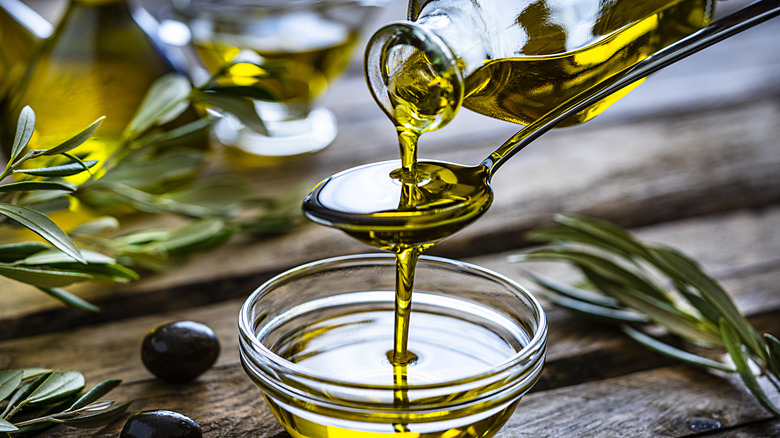 pouring olive oil onto spoon