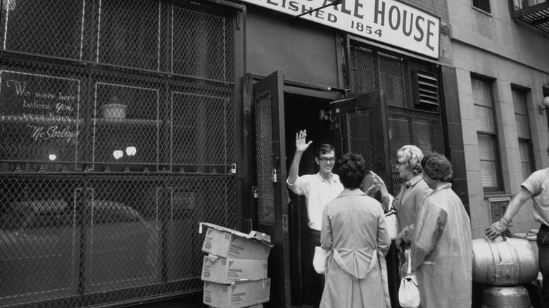 A man puts up his hand to stop women from coming into McSorley's in 1970