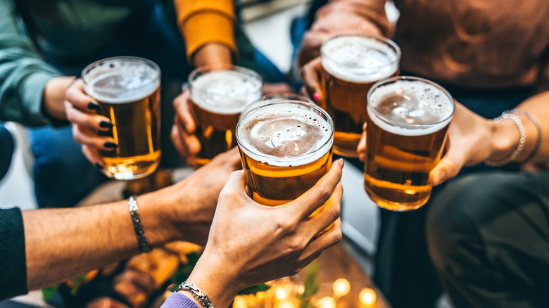 Friends toasting with glasses at a bar