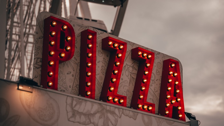 Pizza sign near Ferris wheel