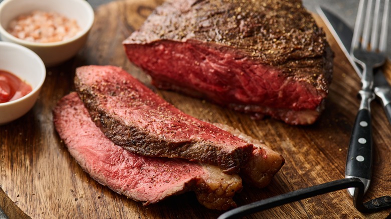 Seasoned steak slices on a cutting board