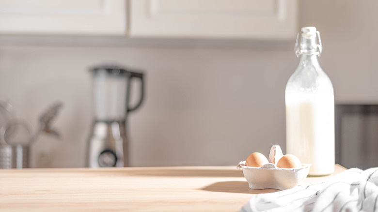 eggs and a bottle of milk on a counter