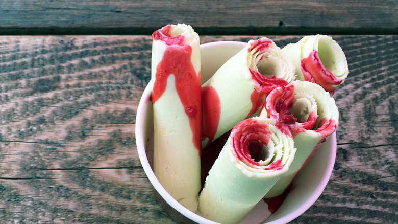 Rolled ice cream with red fruit sauce