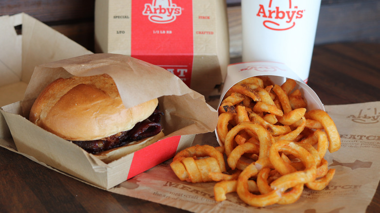 Arby's sandwich, curly fries, and a drink