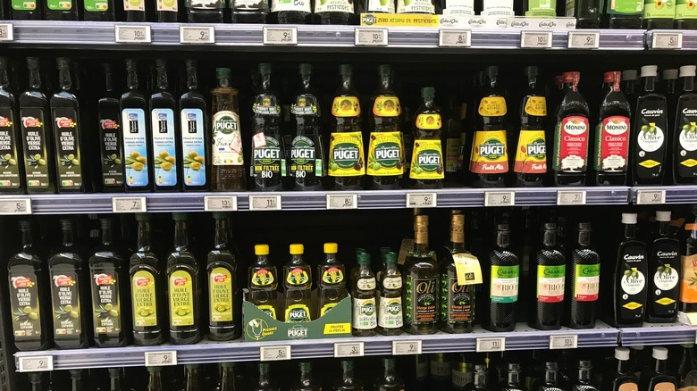 rows of olive oil at grocery store