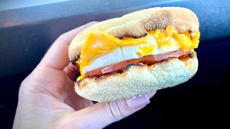 Hand holding an Egg McMuffin