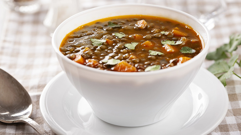 hearty veggie soup in a white bowl