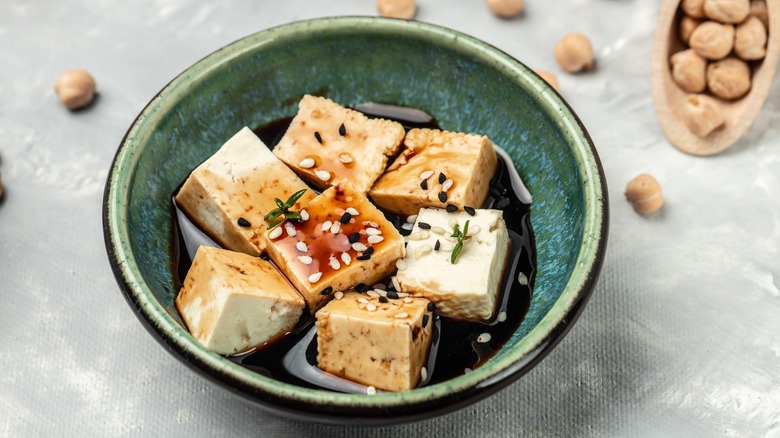 tofu chunks marinating in a dish