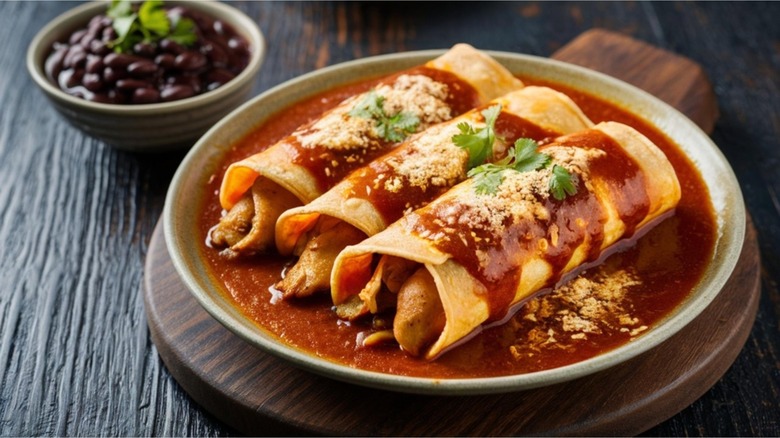 Enchiladas in a red sauce on a plate