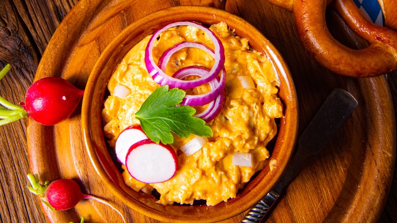 Beer cheese dip with radishes and pretzel