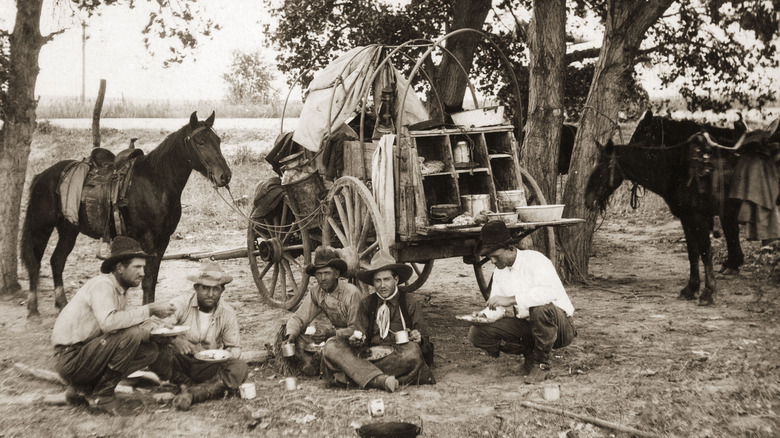 Cowboys in front of wagon