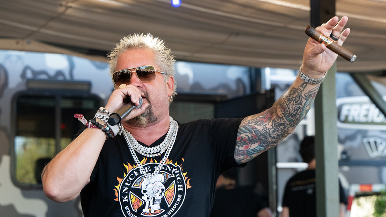 Guy Fieri holding a microphone