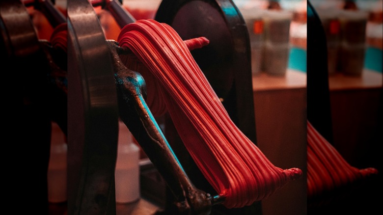 Machine pulling red candy