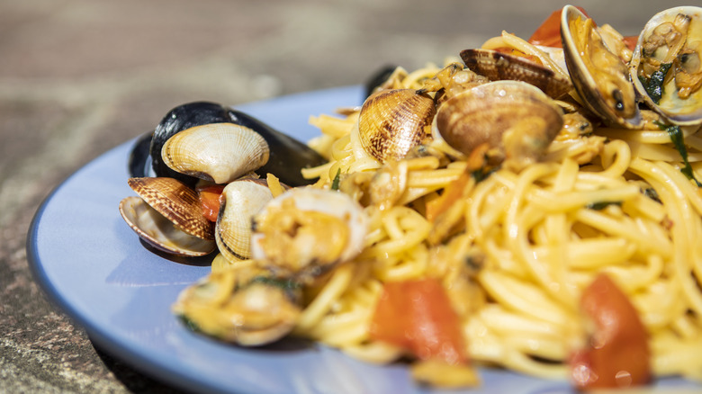 Close-up of a plate of pasta abundant with seafood.