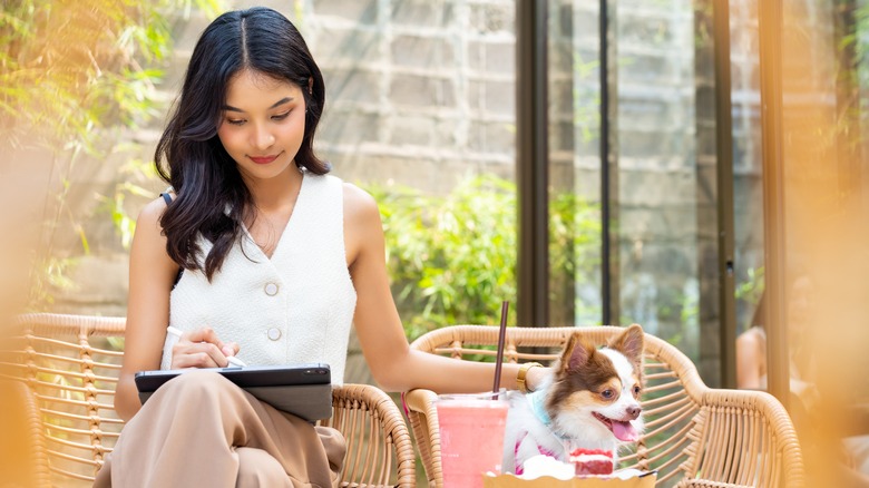 Woman at outdoor cafe with dog