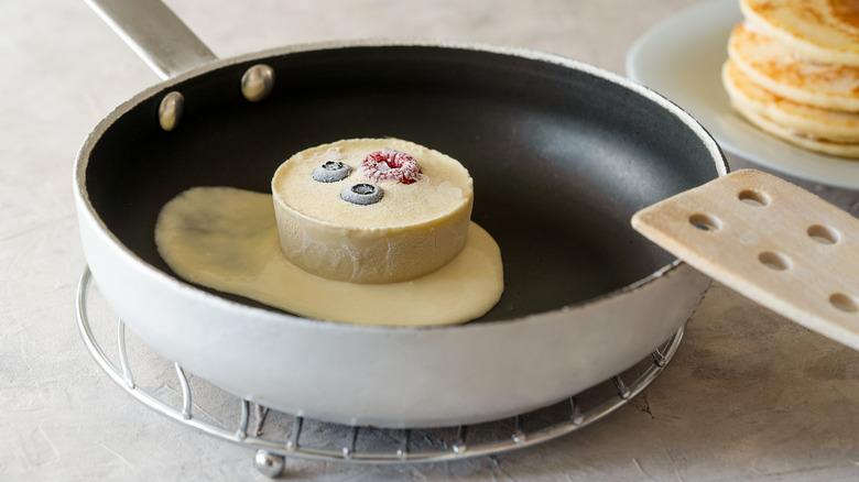 Frozen pancake batter melting into skillet