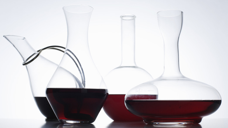 Four decanters of red wine