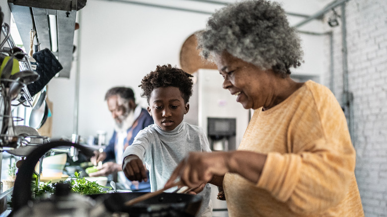 Child and older people cooking