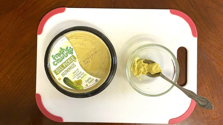 Fresh Cravings' dill pickle hummus on a cutting board