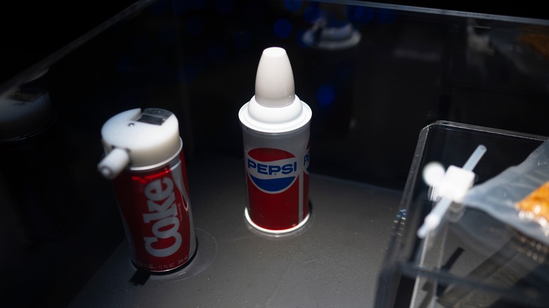 Coke and Pepsi soda can that were built for zero gravity in a display