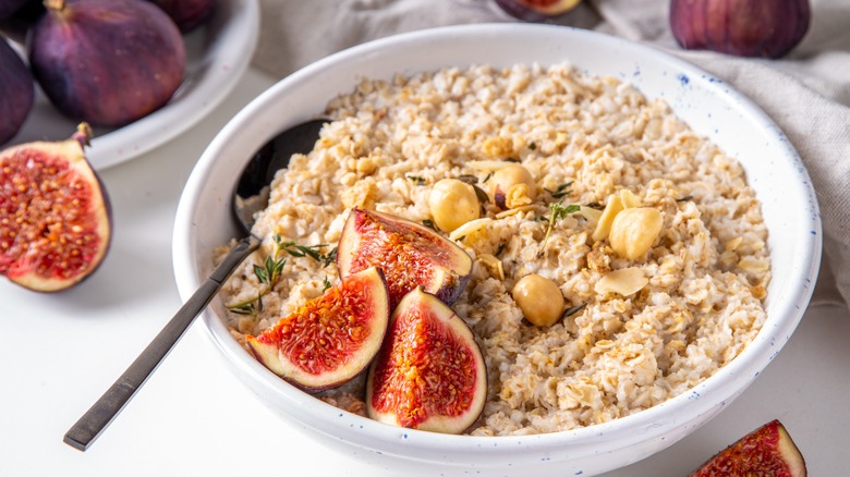 Bowl of oatmeal topped with figs.