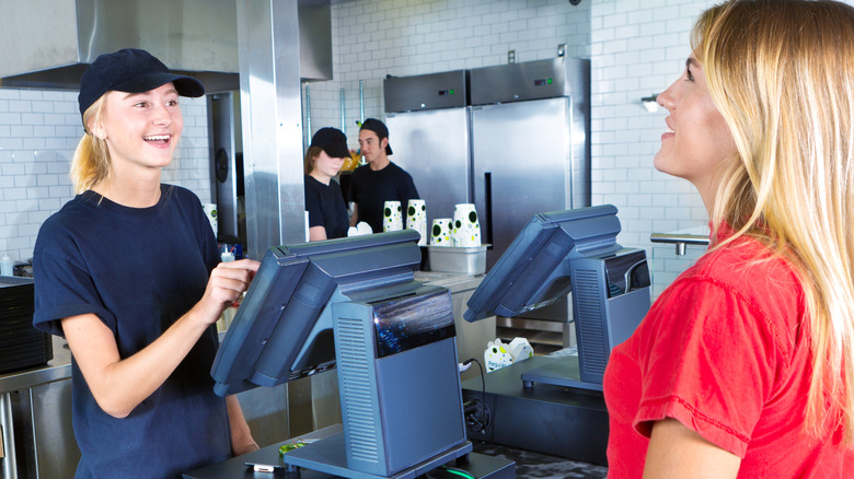 A woman ordering at a fast food counter
