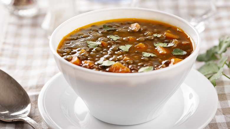 A bowl of lentil soup on a table.