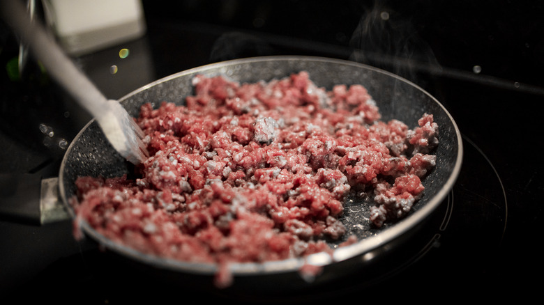 Ground beef cooking in a pan