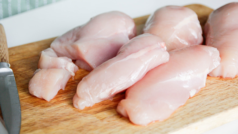 chicken breast displayed on cutting board