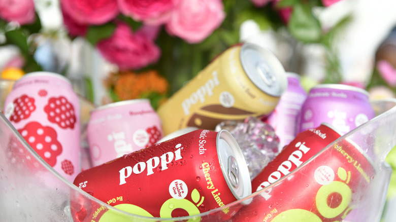 Bowl of Poppi soda cans in different flavors