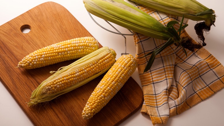 Shucked corn with cutting board