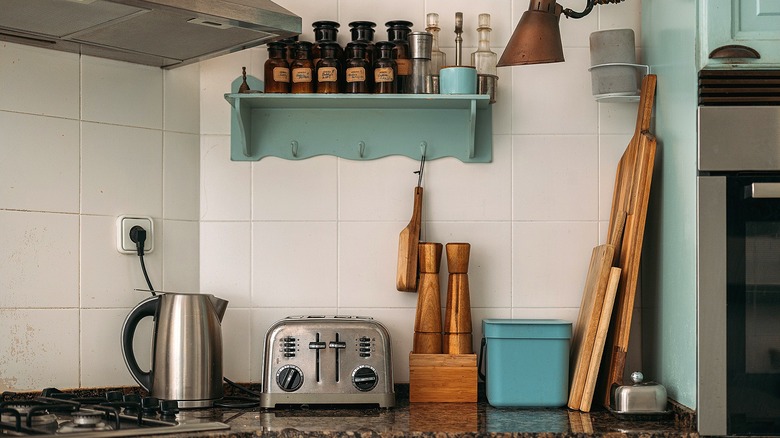 Kitchen counter with toaster, hot water heater, and wooden cutting boards