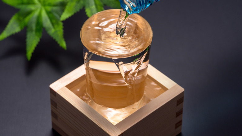 sake poured spillover-style into a glass