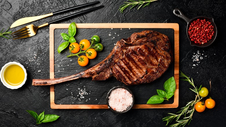 Grilled Tomahawk steak on table