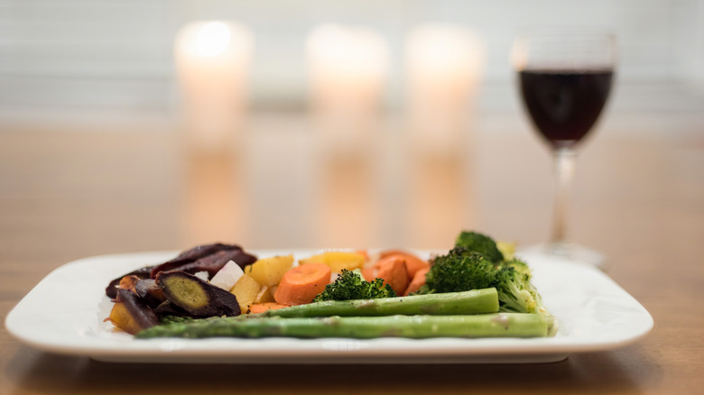 close-up of asparagus on white plate with other veggies