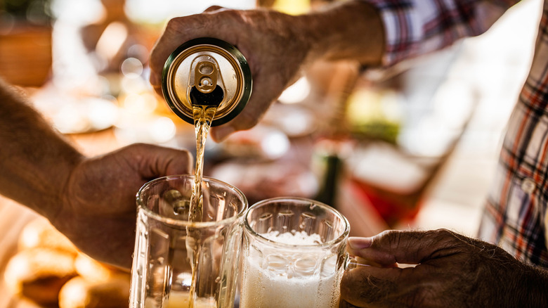 Pouring canned beer into glasses