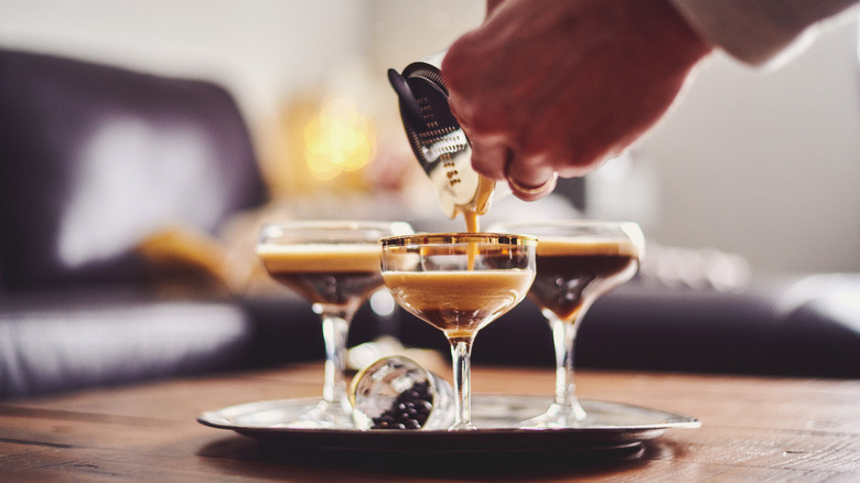 Someone pouring espresso martini cocktails