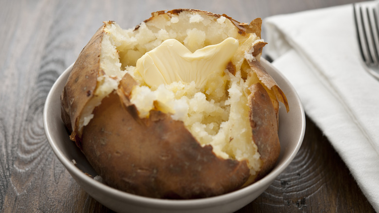 Baked potato on a plate with butter