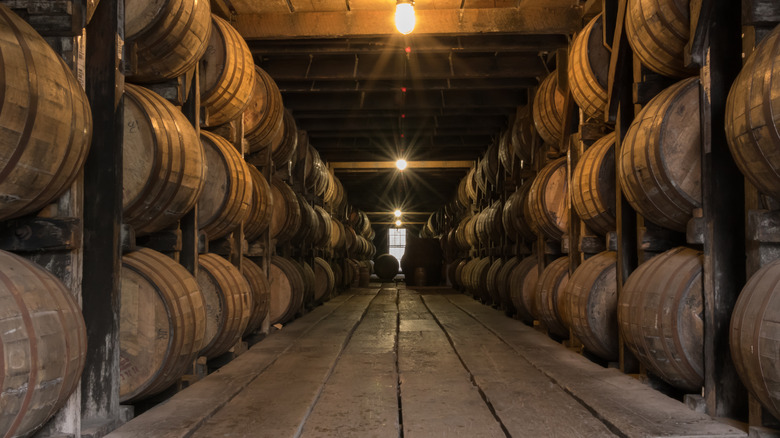 Rows of whiskey barrels aging in a rickhouse